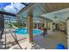 Enjoy the screened-in pool with slide and a relaxing covered patio with ceiling fans at 3181 Canter Ln, Kissimmee, FL 34746