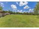 Expansive grassy yard surrounded by trees, bathed in sunshine under a clear blue sky at 3181 Canter Ln, Kissimmee, FL 34746