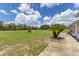 Home with a horse grazing in the grassy field, and a small palm tree near the home at 3181 Canter Ln, Kissimmee, FL 34746