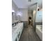 Luxurious bathroom featuring double sinks, a soaking tub, and a separate glass-enclosed shower at 3339 Primrose Willow Dr, St Cloud, FL 34773