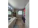 Bright bathroom featuring a dual sink vanity, decorative shelving, and a colorful shower curtain at 3339 Primrose Willow Dr, St Cloud, FL 34773
