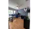 Bedroom features a loft bed, wood floors, a ceiling fan, and playful blue accent wall at 3339 Primrose Willow Dr, St Cloud, FL 34773