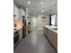 Contemporary kitchen with sleek cabinets, stainless steel appliances, and a view into an open hallway at 3339 Primrose Willow Dr, St Cloud, FL 34773