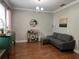 Bright living room featuring hardwood floors, a comfortable gray sofa, and stylish bar cart for entertaining guests at 3339 Primrose Willow Dr, St Cloud, FL 34773