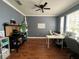 Well-lit office space with hardwood floors, a ceiling fan, and a functional desk setup for remote work at 3339 Primrose Willow Dr, St Cloud, FL 34773