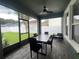 Enclosed patio with dining table, ceiling fan, and view of the fenced backyard at 3339 Primrose Willow Dr, St Cloud, FL 34773
