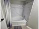 Bathroom features a white tiled tub with a shower head and dark gray accents, creating a modern and stylish space at 3428 Soho St # 208, Orlando, FL 32835