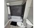 Bathroom featuring a dark tiled tub with a shower head. The room features gray walls, modern floors, and clean design at 3428 Soho St # 208, Orlando, FL 32835