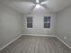 Bedroom features hard floors, a ceiling fan, and two windows with blinds at 3428 Soho St # 208, Orlando, FL 32835
