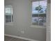 A bedroom with view of water outside the window. The room features gray walls, modern floors, and a minimalist design at 3428 Soho St # 208, Orlando, FL 32835