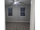 Bright bedroom features hard surface flooring and two windows for ample natural light at 3428 Soho St # 208, Orlando, FL 32835