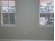 Bedroom featuring two windows with blinds and gray walls at 3428 Soho St # 208, Orlando, FL 32835