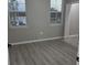A bedroom with view of water outside the window. The room features gray walls, modern floors, and a minimalist design at 3428 Soho St # 208, Orlando, FL 32835
