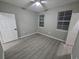 A bedroom featuring hard floors, a ceiling fan, two windows with blinds, and white paint at 3428 Soho St # 208, Orlando, FL 32835