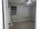 Bedroom features two windows and a ceiling fan. The room features gray walls, modern floors, and a minimalist design at 3428 Soho St # 208, Orlando, FL 32835