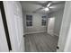 Bedroom with light gray walls, modern floors, and two windows that provide lots of natural light at 3428 Soho St # 208, Orlando, FL 32835