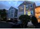Exterior view of condo buildings featuring attached garages and ample parking at 3428 Soho St # 208, Orlando, FL 32835