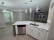 Modern kitchen features stainless appliances, quartz countertops, and an island with seating at 3428 Soho St # 208, Orlando, FL 32835