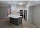 Open kitchen featuring white cabinets, stainless appliances, a center island with quartz countertop, and stylish lighting at 3428 Soho St # 208, Orlando, FL 32835