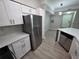 Well-lit kitchen with stainless steel appliances, white cabinets, and quartz countertops with mosaic backsplash at 3428 Soho St # 208, Orlando, FL 32835