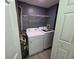 Laundry room with white washer, dryer, and water heater at 3428 Soho St # 208, Orlando, FL 32835