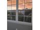 A beautiful sunset and swaying palm trees are visible from the living room window at 3428 Soho St # 208, Orlando, FL 32835