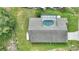 Aerial view of the home showcasing the backyard pool and roof at 373 Shady Oak Loop, Davenport, FL 33896