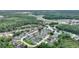 Expansive aerial view of a neighborhood featuring well-maintained homes and lush greenery, nestled amidst a beautiful wooded area at 373 Shady Oak Loop, Davenport, FL 33896