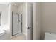 Modern bathroom featuring a walk-in shower with black hardware, white tiling, and neutral tile flooring at 373 Shady Oak Loop, Davenport, FL 33896
