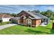 Well-kept single-story home with a dark roof, solar panels, attached two-car garage and fenced-in pool at 373 Shady Oak Loop, Davenport, FL 33896