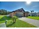 Charming single-story home with a well-manicured lawn, mature landscaping, and a two car garage at 373 Shady Oak Loop, Davenport, FL 33896
