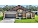 Charming single-Gathering home with a well-manicured lawn and a two-car garage at 373 Shady Oak Loop, Davenport, FL 33896
