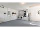 Garage featuring a laundry area, utility sink, water heater, painted floor, and breaker panel at 373 Shady Oak Loop, Davenport, FL 33896