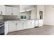 Charming kitchen features white cabinets, stainless steel appliances, granite counters, and durable floors at 373 Shady Oak Loop, Davenport, FL 33896