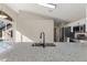 Bright kitchen featuring granite countertops, stainless steel appliances, and a modern sink under bright recessed lighting at 373 Shady Oak Loop, Davenport, FL 33896