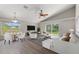 Open-concept living room with modern decor, vaulted ceilings, ample seating, and lots of natural light at 373 Shady Oak Loop, Davenport, FL 33896