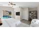 Spacious main bedroom featuring pool access, neutral decor, and an ensuite bathroom at 373 Shady Oak Loop, Davenport, FL 33896
