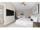 Bright main bedroom featuring a large tv, neutral decor, and an ensuite bathroom at 373 Shady Oak Loop, Davenport, FL 33896