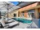 Inviting in-ground pool, lounge chairs, and a covered patio for relaxation and entertainment at 373 Shady Oak Loop, Davenport, FL 33896