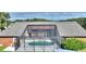 Aerial view of an enclosed pool, complete with dark screening and patio with lush vegetation at 373 Shady Oak Loop, Davenport, FL 33896