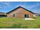Rear exterior view of the home highlighting the patio and access to the backyard at 373 Shady Oak Loop, Davenport, FL 33896