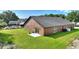 Rear exterior view with a well-maintained lawn and patio access, blending indoor and outdoor living at 373 Shady Oak Loop, Davenport, FL 33896