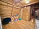 Attic area featuring wood-paneled walls and ceiling, with a sloped roofline and wood floors at 4075 Packard Ave, St Cloud, FL 34772