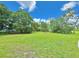 Expansive backyard with healthy green grass, mature trees, and a quiet, inviting atmosphere at 4075 Packard Ave, St Cloud, FL 34772