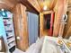 Narrow bathroom featuring a unique sink and wood-paneled walls at 4075 Packard Ave, St Cloud, FL 34772