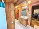 Compact bathroom with a wooden vanity and wood-paneled walls at 4075 Packard Ave, St Cloud, FL 34772