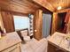 Cozy bathroom features white tiled floors, wood walls, sink and a shower with a patterned curtain at 4075 Packard Ave, St Cloud, FL 34772