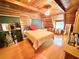 Inviting bedroom with a wood-paneled walls, ceiling fan and a sloped ceiling at 4075 Packard Ave, St Cloud, FL 34772