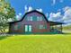Stunning two-story home with a covered porch, lush lawn, and charming details at 4075 Packard Ave, St Cloud, FL 34772