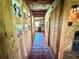 Charming hallway features warm wood paneling, tile flooring, and access to the kitchen area at 4075 Packard Ave, St Cloud, FL 34772